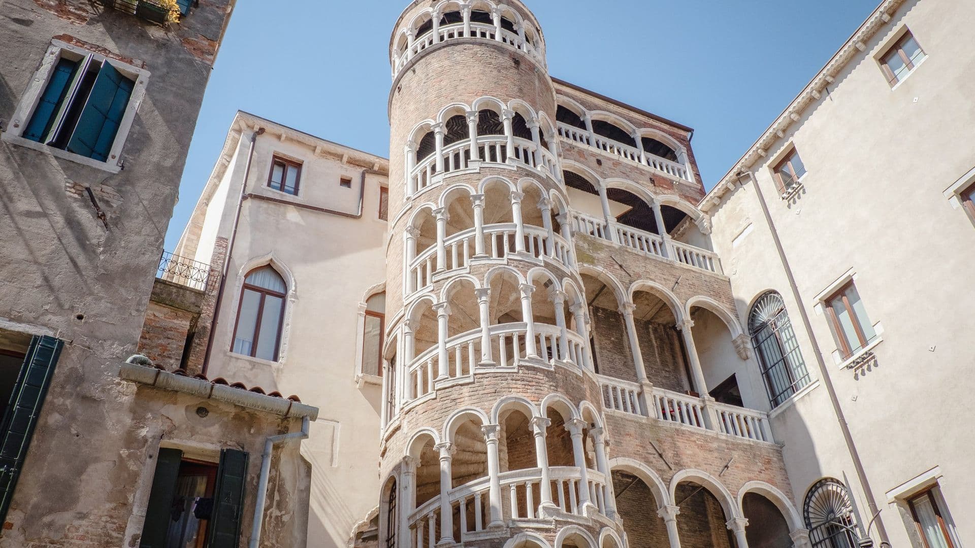 Spiral staircase with arches on a historic building in Venice, Italy